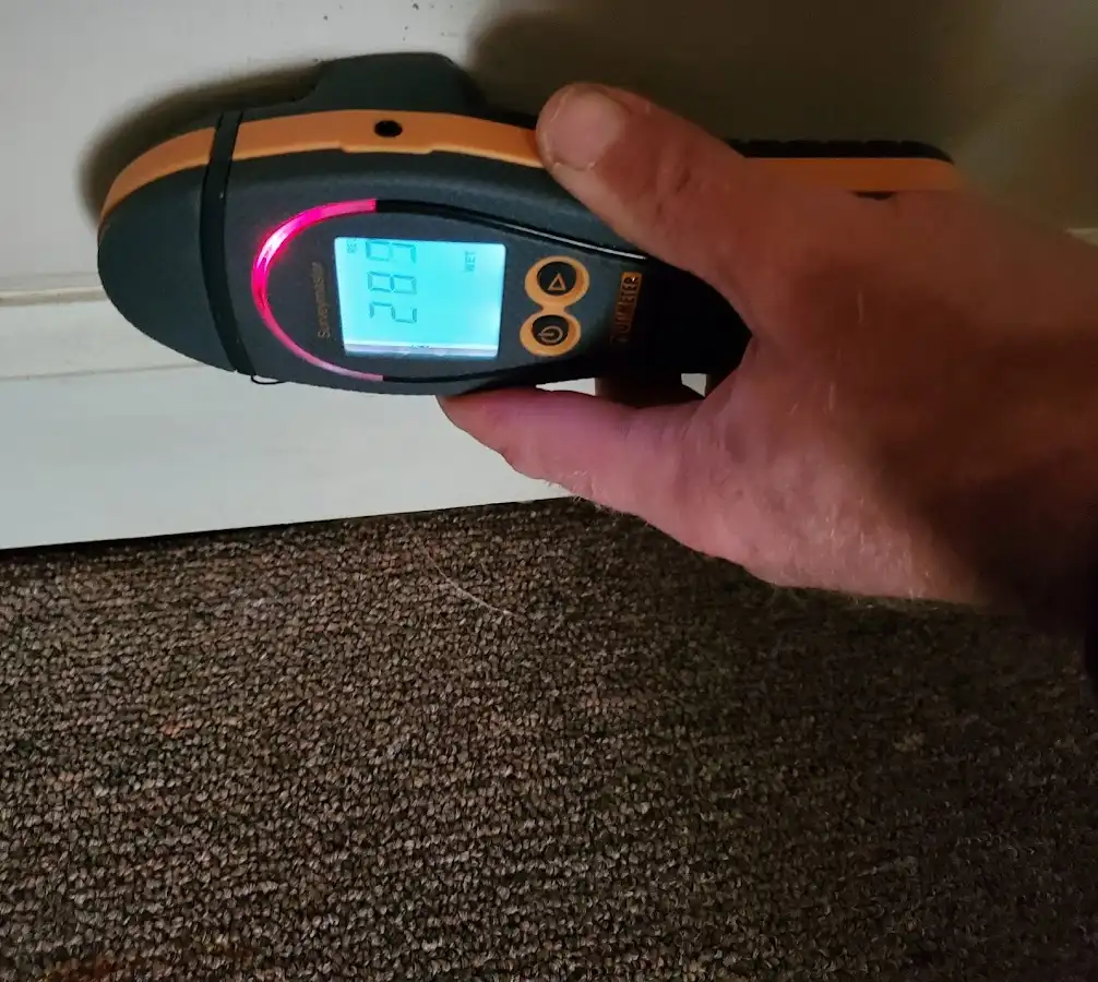 Moisture detection at baseboard during Storm Damage Restoration in Berkley